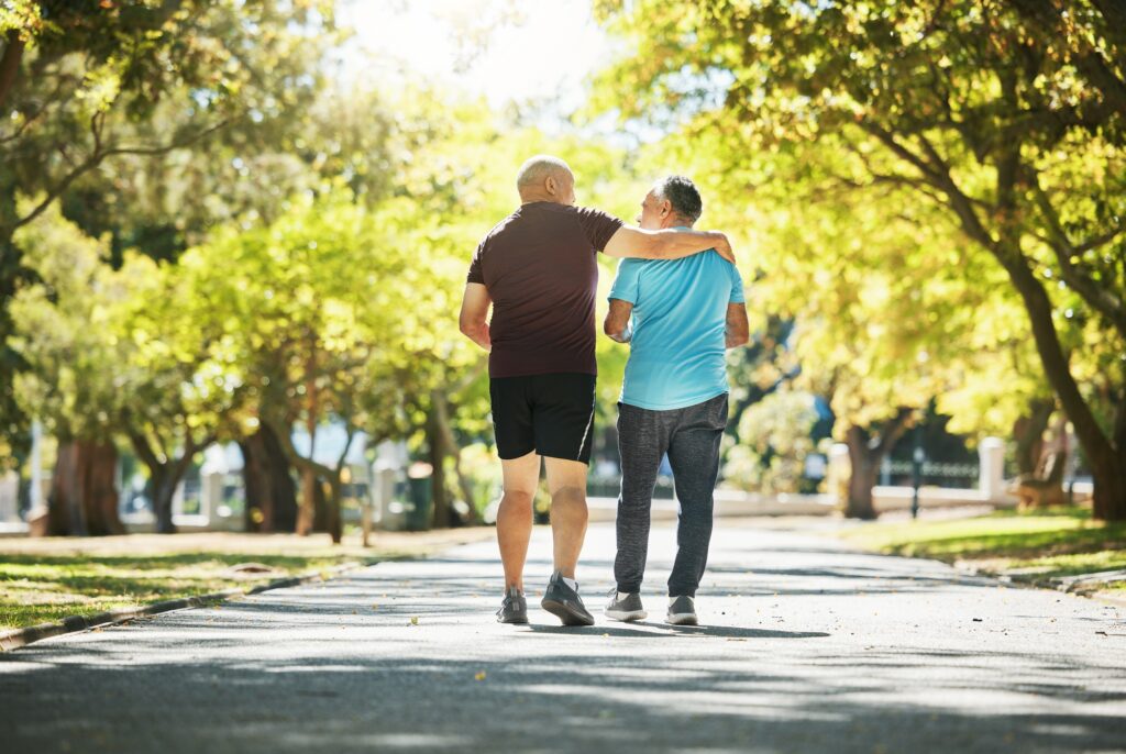 Park, walking and back of senior men for wellness, healthy body and wellbeing in retirement, Friend